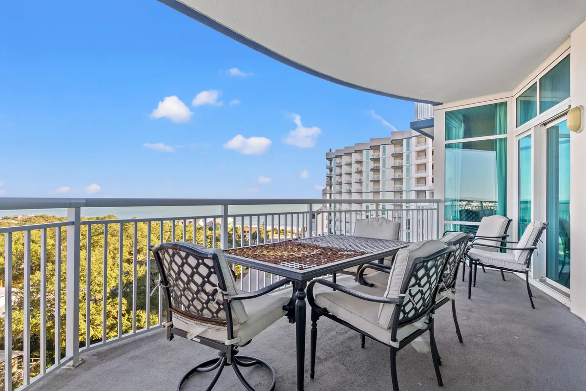 An inviting outdoor dining area featuring a table set against a sweeping ocean view and lush greenery, ideal for al fresco meals, sunset gatherings, or relaxed evenings under the stars.